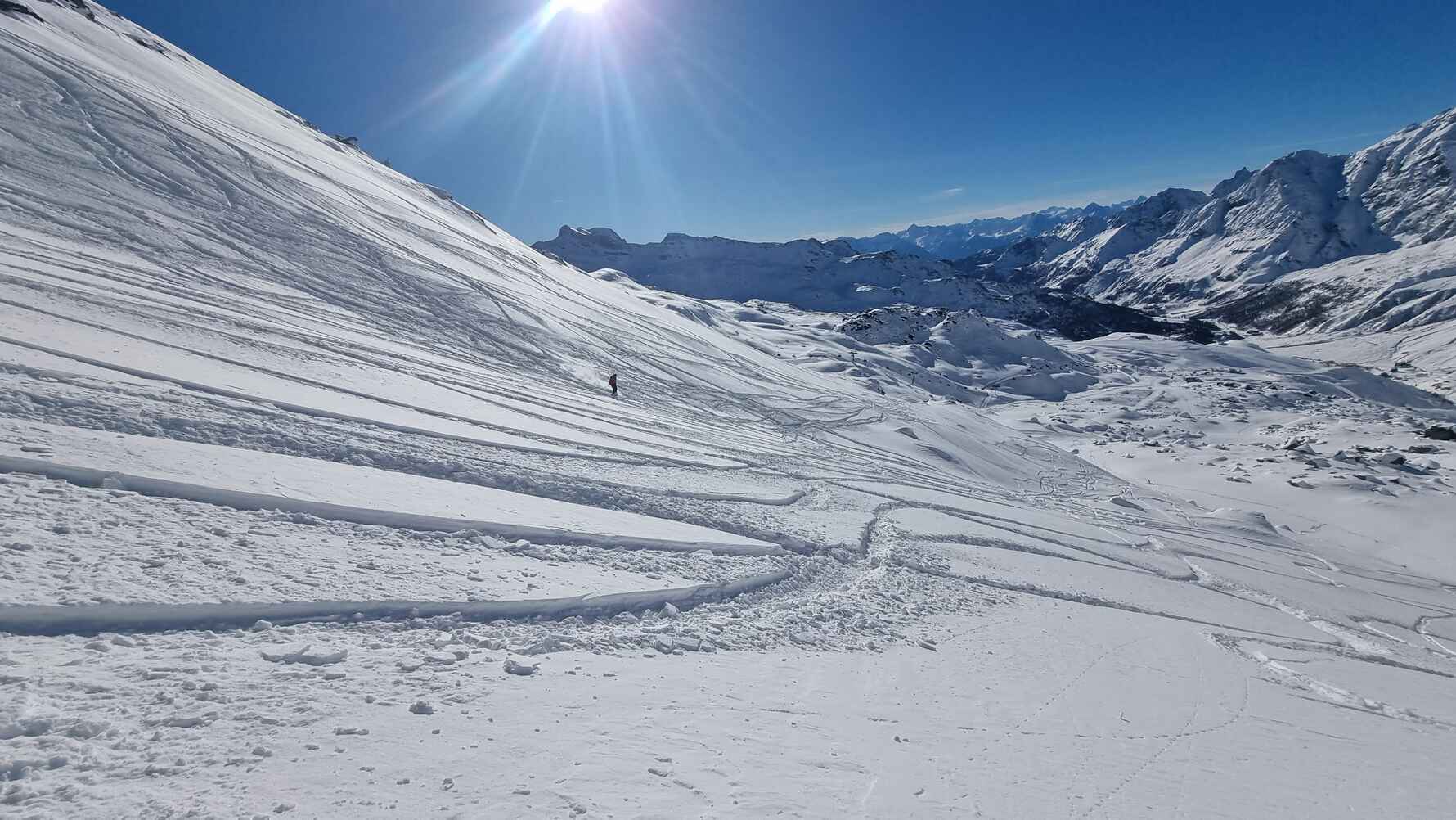 A solo skier on powder snow in Cervinia