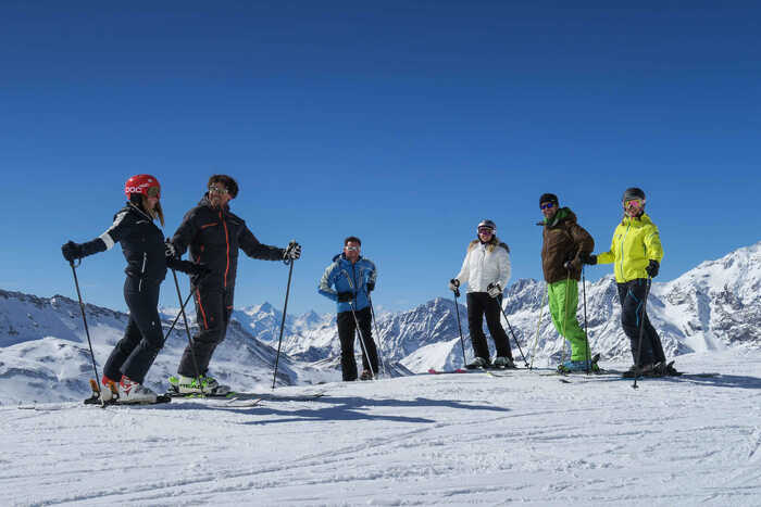 A group of solo skiers on the piste