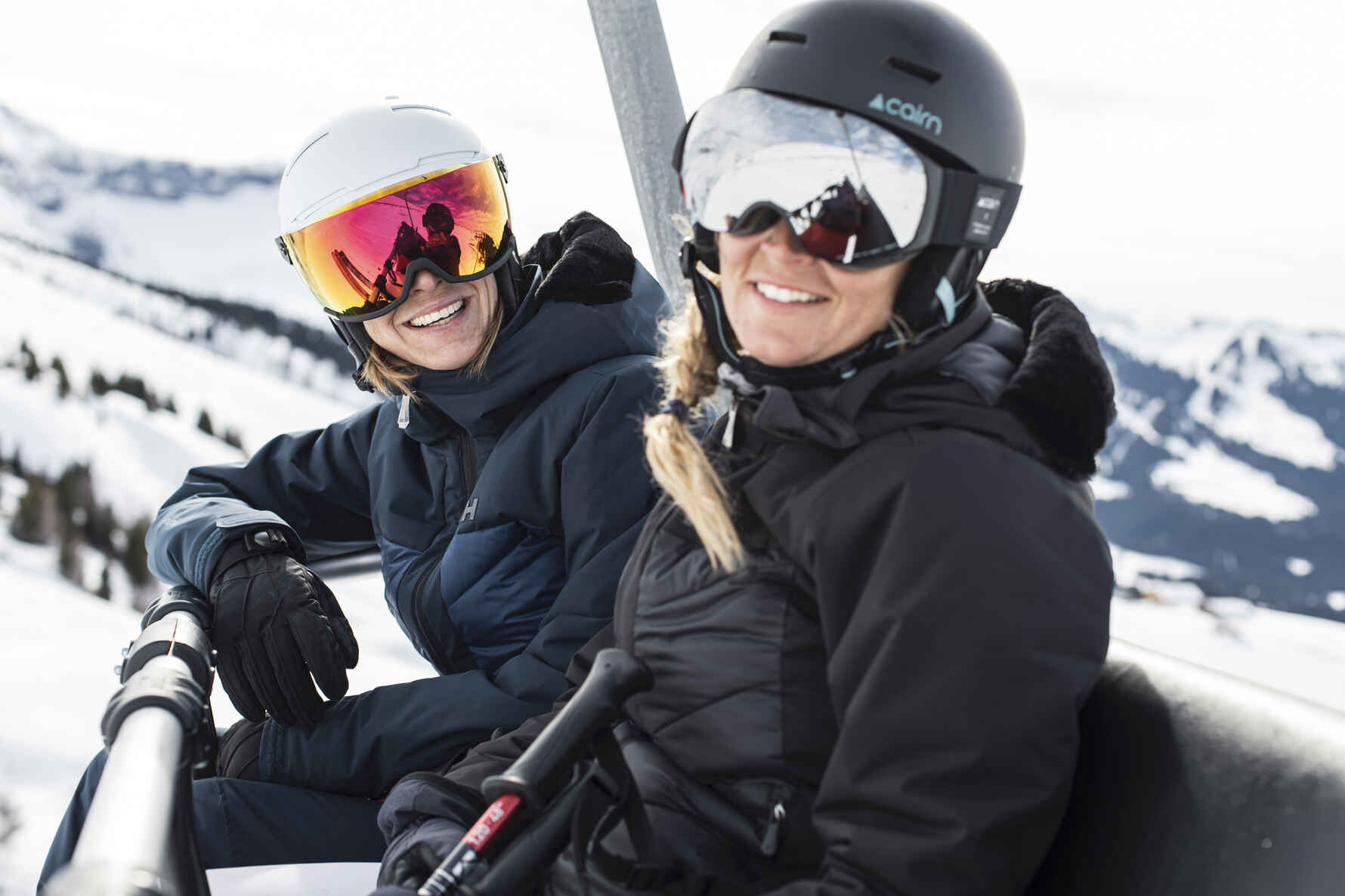 two solo skiers on a chairlift